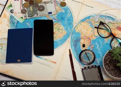 Plan of trip. background - what to take for a trip. map, retro camera, money, sunglasses, coins, headphones, passport, compass, phone,