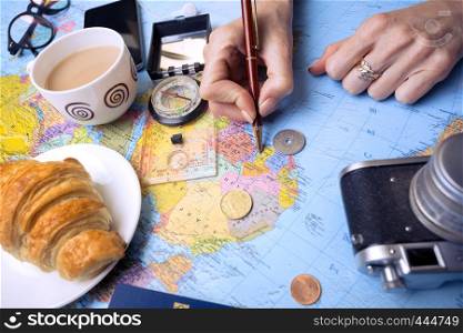 Plan of trip. background - Women's hands and map, retro camera, money, compass