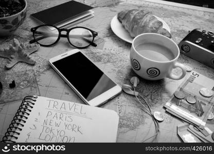Plan of trip. map, retro camera, money, sunglasses, notepad for writing ideas, coins, headphones, smartphone,