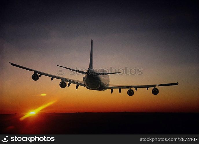 Plane Flying at Sunset