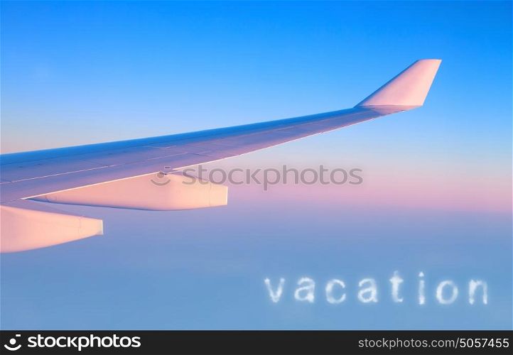 Plane in the air, wing of great luxury aeroplane on blue&pink sky background, business trip, travel and vacation concept