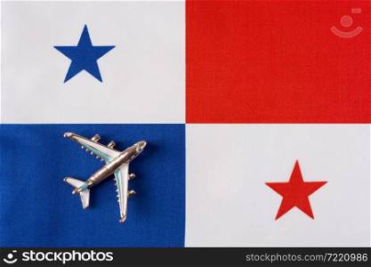 Plane over the flag of Panama travel concept. Toy plane on a flag in the background.. Plane over the flag of Panama travel concept.