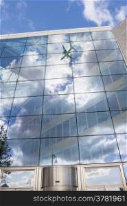 plane reflected in a building. Stock