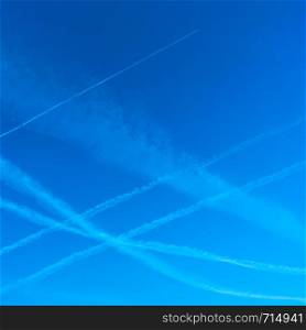 Plane trails in the blue sky - Background