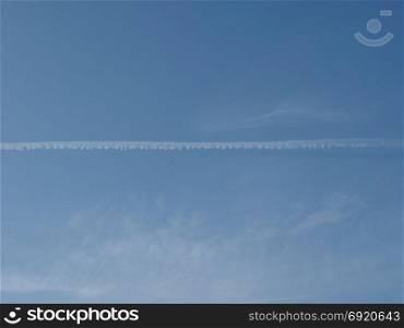 plane trails in the sky. blue sky with plane vapour trails (aka contrails, short for condensation trails)