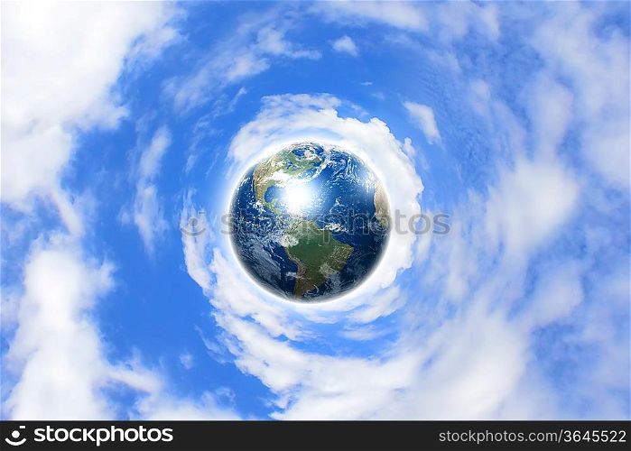 Planet earth against blue cloudy sky background