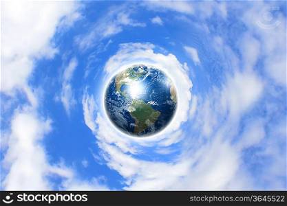 Planet earth against blue cloudy sky background