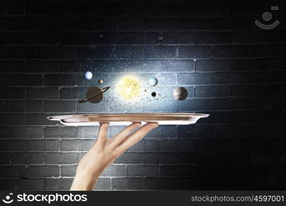 Planets of sun system. Close up of hand holding tray with sun system planets