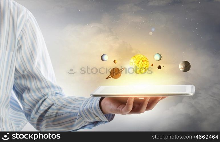 Planets of sun system. Close up of hand showig tablet and media application