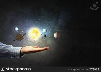 Planets of sun system. Close up of planet sun system in man hand