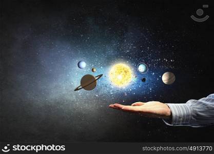 Planets of sun system. Close up of planet sun system in man hand