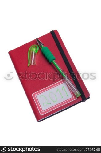 planning 2011, notebook and pen lying on the top (isolated on white background)