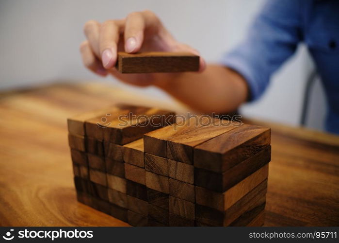 Planning risk and strategy in businessman gambling placing wooden block.Business concept for growth success process.