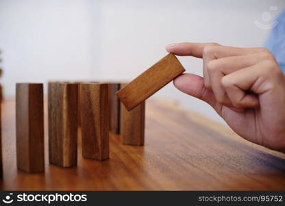 Planning risk and strategy in businessman gambling placing wooden block.Business concept for growth success process.