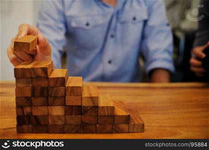 Planning risk and strategy in businessman gambling placing wooden block.Business concept for growth success process.