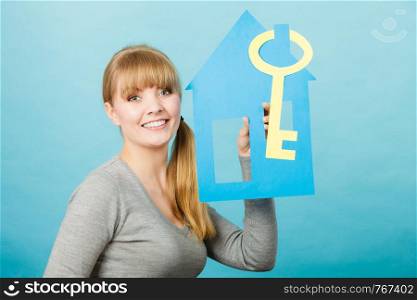 Plans ideas and concepts for future. Young joyful blonde woman with house and big key. Charming girl enjoy her decision of buying real estate.. Blonde woman with house and key.