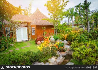 plant and flower tree decorate on front yard with walkway and stone in pond cottage garden background