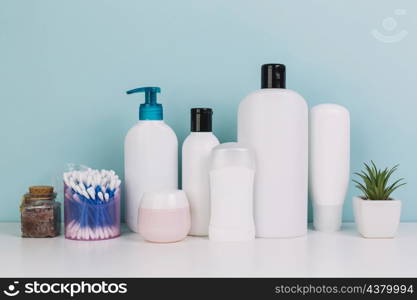 plant cotton swabs near cosmetics bottles