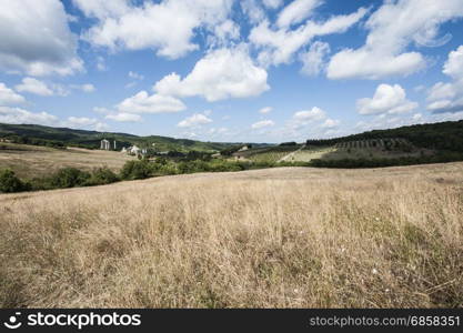 Plant for agricultural products processing inTuscany. Italian wine farm surrounded with vineyards and olive trees.