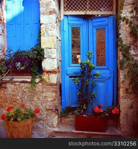 Plant pots and a slap of paint turn a crumbling doorway in Rethymnon, Crete, into a piece of picturesque Greek culture. Medium format slide film.