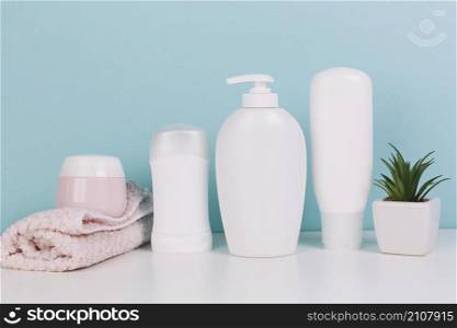 plant towel near cosmetics bottles