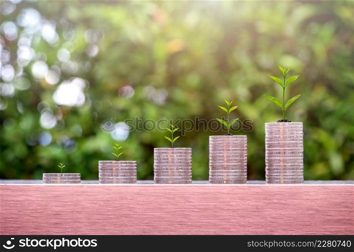 Plants on coin stacks in increase. Money growth and pension fund concept.