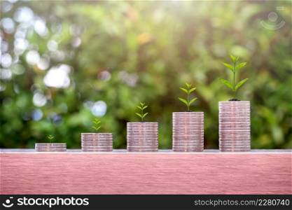 Plants on coin stacks in increase. Money growth and pension fund concept.