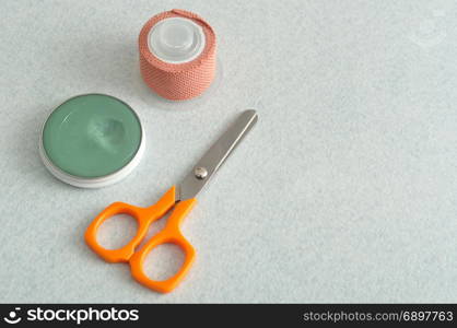 Plaster, scissor and ointment