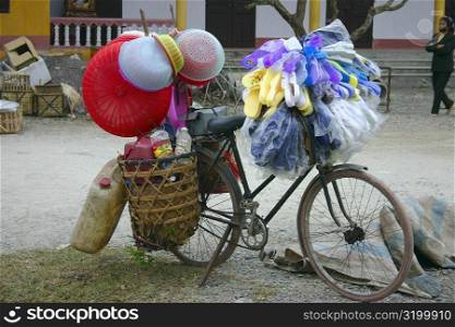 Plastic baskets and flip-flops hanging on a bicycle, Dong Hoi, Vietnam
