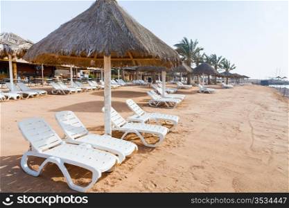 plastic beach beds on coral bay in Aqaba, Jordan