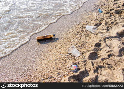 Plastic bottle and other pollution garbage on the beach at caused by much volume tourists popular tourist destination.