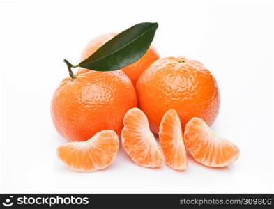 Plastic bottle of fresh mandarin tangerine juice with fresh fruits in wooden box on light wood background