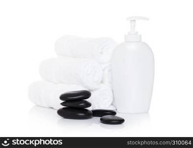 Plastic bottle of organic shampoo with spa towels and stones on white background