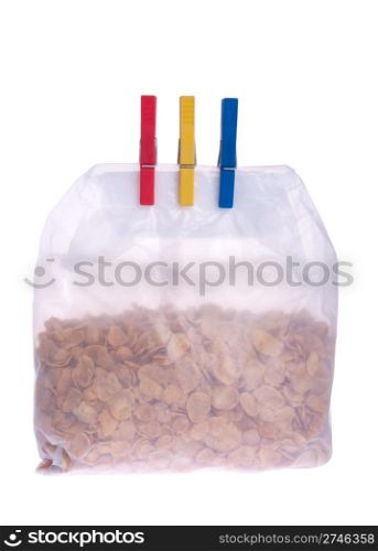 plastic cornflakes bag with clothes pegs isolated on white background