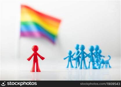 Plastic figure, LGBT rainbow flag and heterosexuals on light gray background. Equal rights for lgbtq community concept