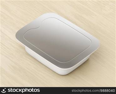 Plastic food container with silver lid on the wooden table