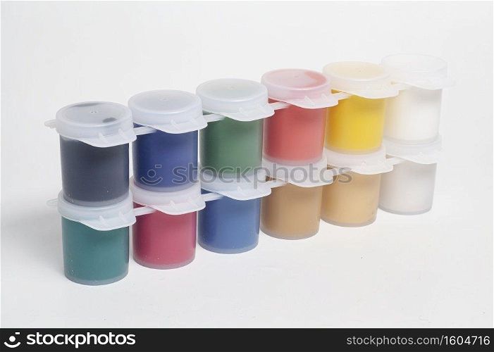 Plastic jars with multicolored gouache paints.. Plastic jars with multicolored gouache paints