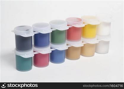 Plastic jars with multicolored gouache paints.. Plastic jars with multicolored gouache paints