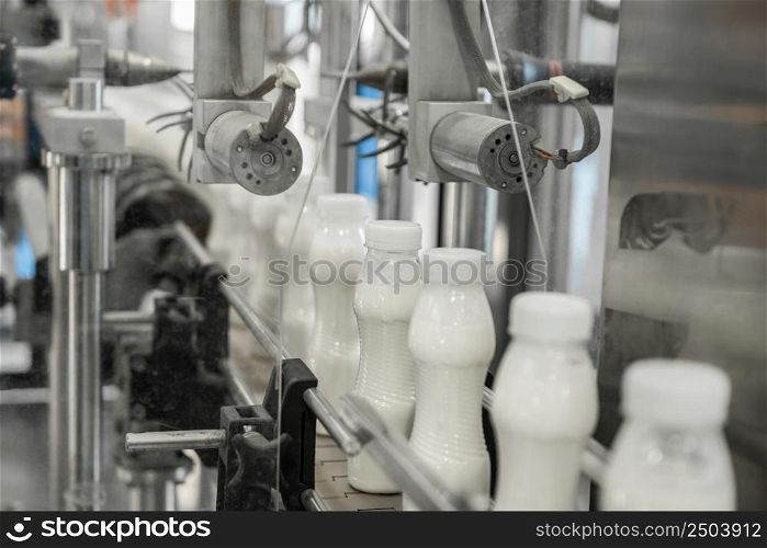 plastic milk bottles on conveyor belt. equipment at the dairy plant. equipment at the milk factory