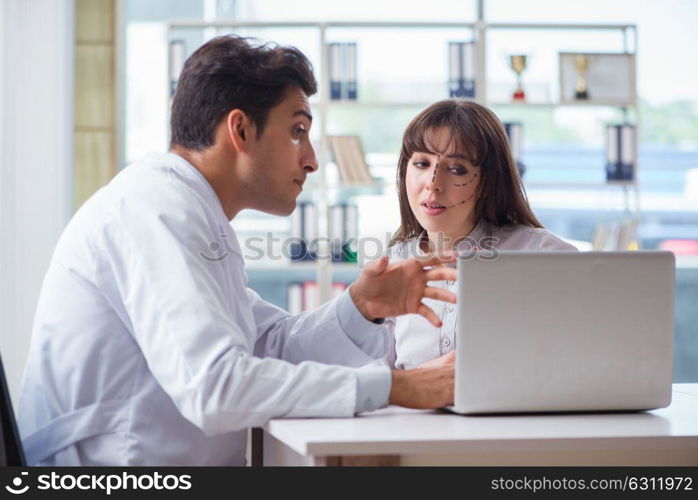 Plastic surgeon preparing for operation on woman face. The plastic surgeon preparing for operation on woman face