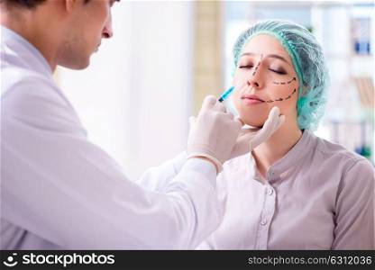 Plastic surgeon preparing for operation on woman face. The plastic surgeon preparing for operation on woman face