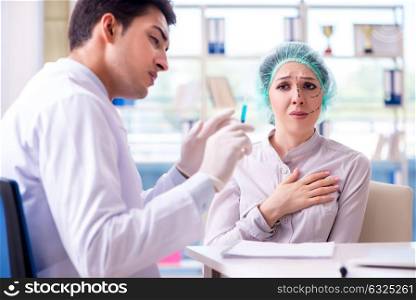 Plastic surgeon preparing for operation on woman face. The plastic surgeon preparing for operation on woman face