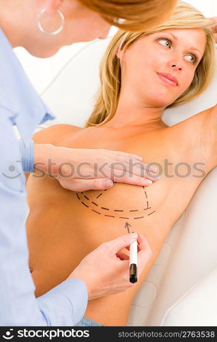 Plastic surgery female doctor draw line patient breast augmentation implant