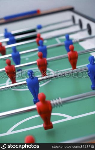 Plastic tabletop football with red and blue figures.