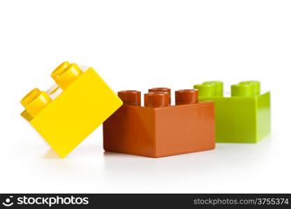 Plastic toy blocks on white background. Group of building blocks