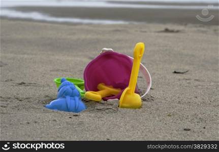plastic toys on the beach with bucket sppon and rake