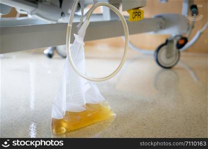 Plastic urine collection bag hang under patient bed in hospital, AF point selection.