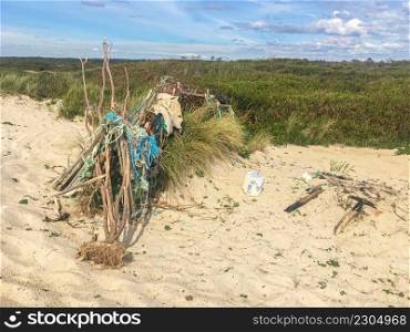 Plastic waste on Furadouro beach in Ovar, Portugal. Trash, plastic, garbage, bottle. Environmental pollution on sandy beach.