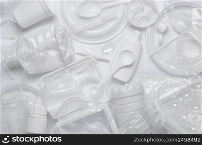 Plastic waste. White single-use plastic products garbage. Top view flat lay.