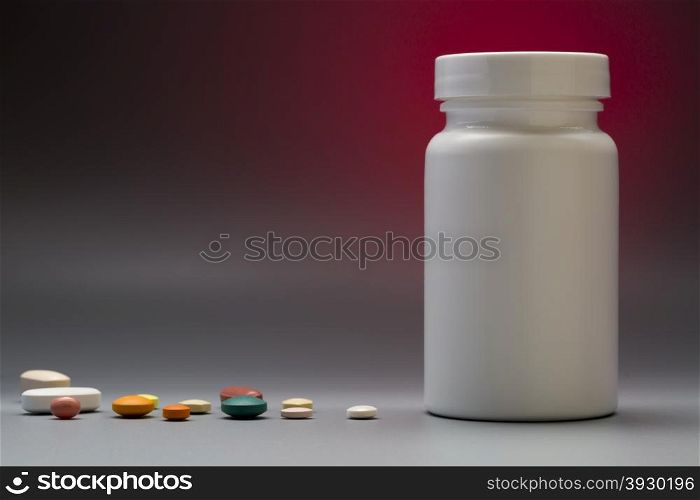 Plastic white medical bottle on a colorful background. Plastic medical bottle with pills on copy space